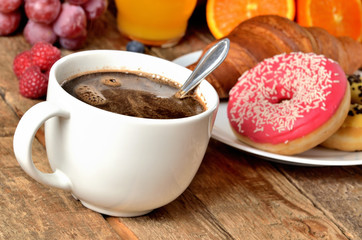 Turkish coffee, croissant, donuts, fresh fruit - grapes, orange and juice - breakfast