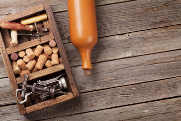Wine bottle, corkscrew and corks