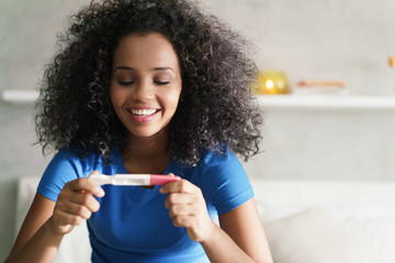 Happy Woman Smiling For Joy With Pregnancy Test Kit