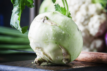 Green kohlrabi cabbage, brown background, selective focus