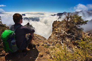 Resting man watching a landscape in the volcanic crater Caldera de Taburiente, Island of La Palma, Canary Islands, Spain