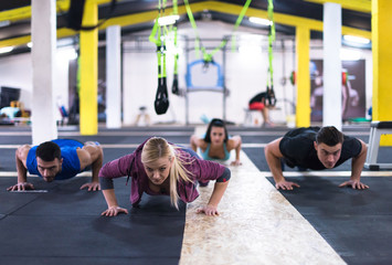 young healthy people doing pushups