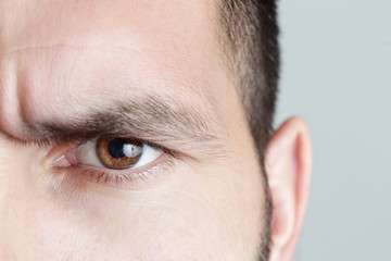 Close up view of a brown man eye looking at camera