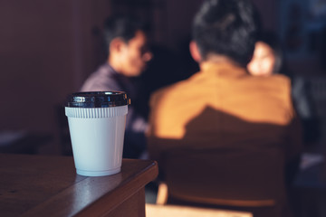 Cup of hot coffee with business team discussing to ideas at meeting background, Teamwork concept