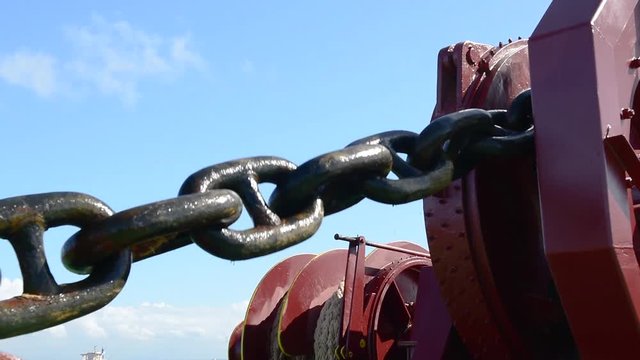 A cargo ship heaving up her anchor