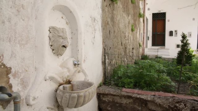 Small fountain in a street in Italy 