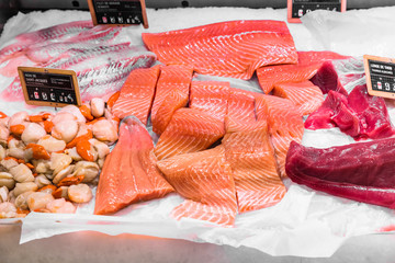Scallops, salmon and tuna fillet on display in a French supermarket. Paris, France