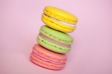 French macaroon biscuits on pastel pink background