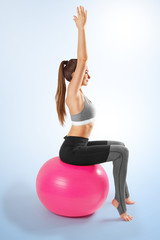 Pilates and fitness sport girl in yoga fitness exercise on the floor, indoor training sitting on...