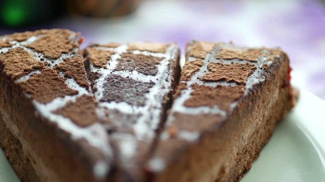 Piece og dark delicious chocolate cake on plate on table