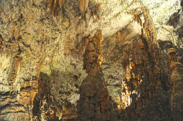 underground view of stalactites and stalagmites in natural halls in Postojna cave, Slovenia, Europe