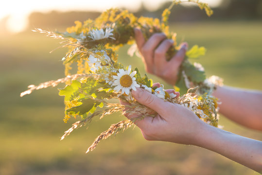 Midsummer In Latvia: Celebration Of Ligo - A Young Woman Weave A Wreath And Collect Field Flowers