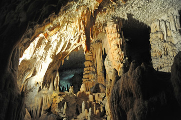 underground view of stalactites and stalagmites in natural halls in Postojna cave, Slovenia, Europe