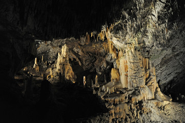 underground view of stalactites and stalagmites in natural halls in Postojna cave, Slovenia, Europe