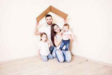 Happy young family under a safe roof, concept