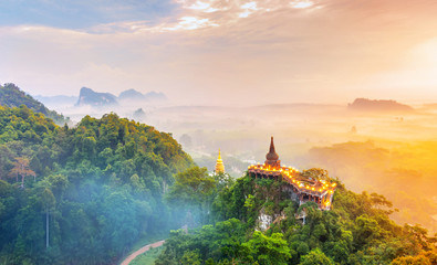 Landscape of beautiful sunrise with pagoda on peak mountain and tree with misty morning at Na Nai...