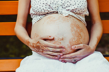 Pregnant Woman with mehndi painting