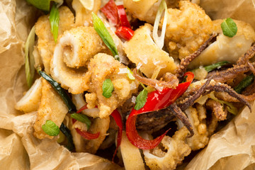 Fresh Greek Squids Calamari with Red Hot Chili Pepper on Rustic Wooden Background