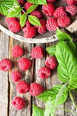 Fresh organic raspberries with leaves, selective focus. Fruit background.