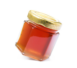 Glass of bee honey isolated on white background