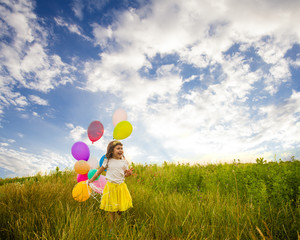 Girl with ballons against blue sky