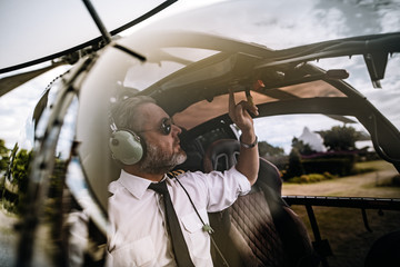 Pilot starting the controls on helicopter © Jacob Lund