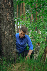 Tourist sewing tree in the forest
