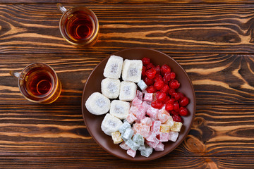 Tea with rahat  and dried fruits on a wooden table