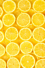 A slices of fresh juicy yellow lemons.  Texture background, pattern