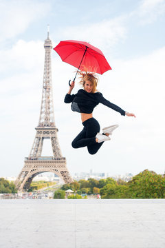 Girl with beauty look at eiffel tower. Woman jump with fashion umbrella. Parisian isolated on white background. Happy woman travel in paris, france. Travelling and wanderlust. Enjoy summer vacation