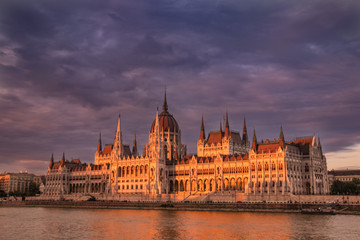 Fototapeta na wymiar Hungarian parliament building in Budapest at sunset, view from the Danube river