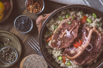 Lamb Loin Chops Freshly Roasted with Soybean and Couscous in Rustic Clay Dish
