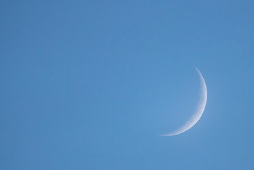 Obraz na płótnie Canvas New Moon in the daytime on the day blue sky