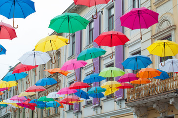 Fototapeta na wymiar Many colorful umbrellas on the open sky