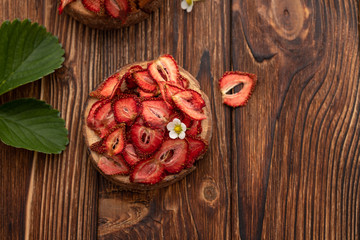 Dried strawberry on a wooden background. Summer concept.Top view.