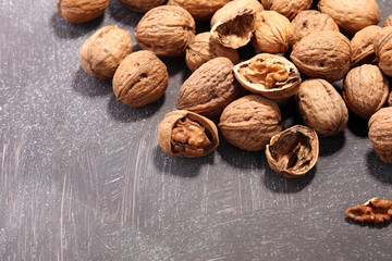 Walnut kernels and whole walnuts on rustic old table