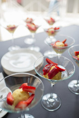 A glasses with ice cream with a strawberries