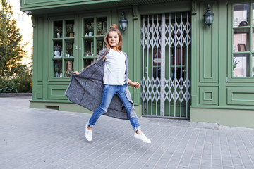 Portrait of a beautiful girl in casual clothing outside french cafe in the street