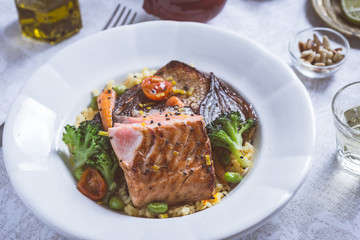 Salmon Fillet with Vegetables on Rustic White Plate
