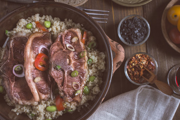 Lamb Loin Chops Freshly Roasted with Soybean and Couscous in Rustic Clay Dish