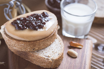 Fresh Peanut Butter and Jelly Sandwich on Old Rustic Wooden Cutting Board