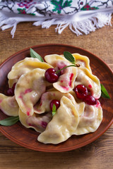 Dumplings, filled with cherries, berries. Pierogi, varenyky, vareniki, pyrohy - dumplings with filling, popular dish in many countries