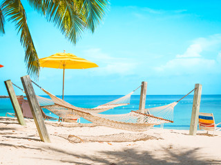 Hammocks and umbrellas beach travel postcard with copy space