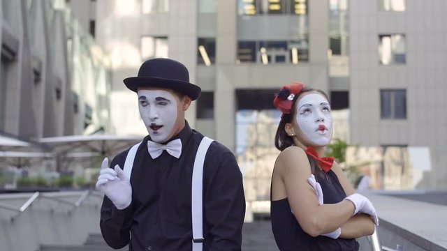 Handsome man mime give invisible flower to his girlfriend