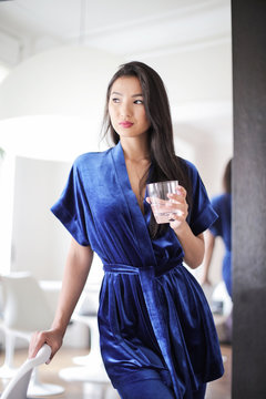 Portrait of asian girl holding a glass of water