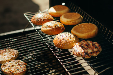 Buns for hamburgers with sesame, grilled meatballs.