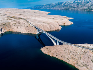 Bridge to island Pag and Adriatic sea and mountain range Velebit, Jadransko more, Croatia, aerial shot with drone