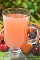 Traditional summer drink sangria - red, pink and white. With champagne, pink and red wine, strawberries, oranges, lemon, green apple and grapefruit. On a wooden rustic table, copy space
