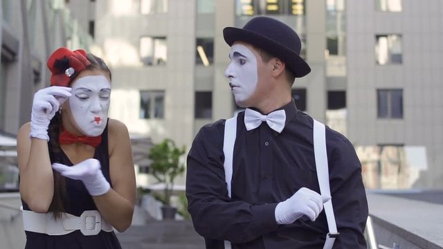 Three funny mimes playing their roles at office center background