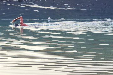 A man is swimming in the sea